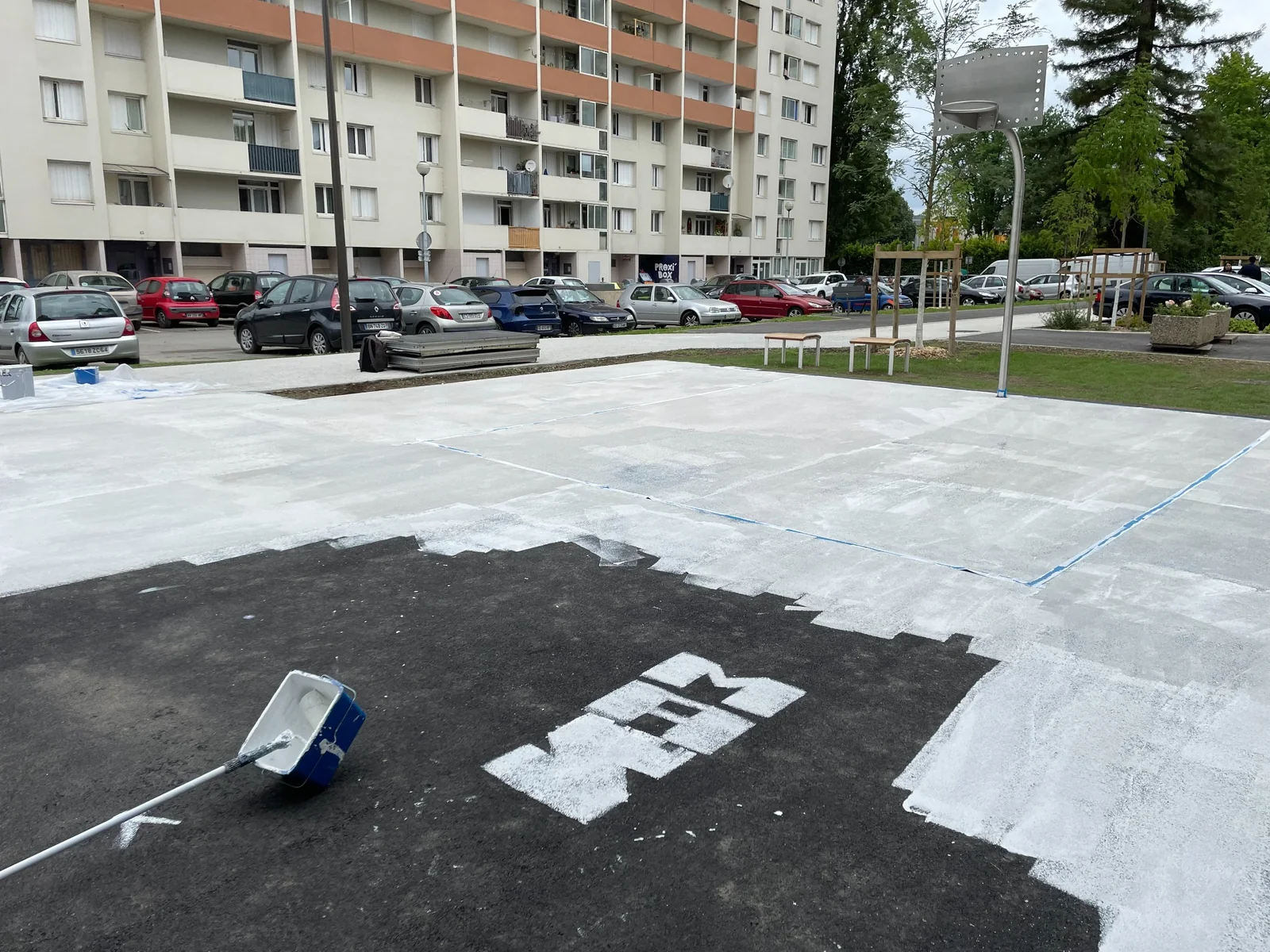 Préparation du sol du playground de basket à Pau avant la peinture participative